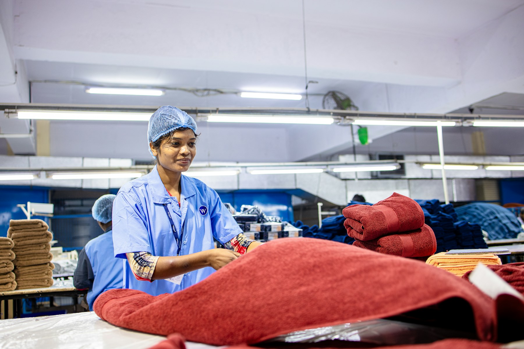 Textile professional inspecting fabric rolls